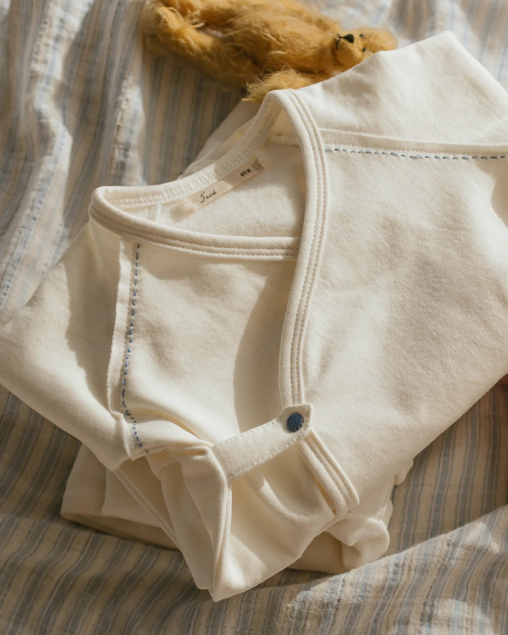 ferne baby Flap Footie - Milk with Blue Stitching